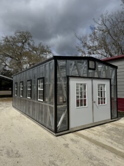 12x24 greenhouse with double 9-lite door, electric, composite floor, and shelving – exterior view in Gainesville, FL